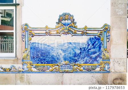 A stunning and beautifully crafted tile mural in blue and yellow that vividly depicts an enchanting scenic landscape A stunning and beautifully crafted tile mural in blue and yellow that vividly depicts an enchanting scenic landscape 117978653