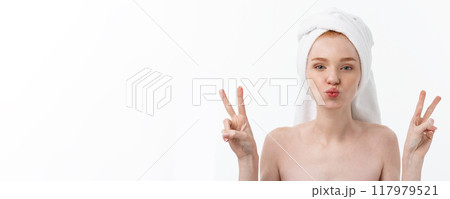 Beautiful caucasian woman applying mask on her face with two fingers sign white background. 117979521