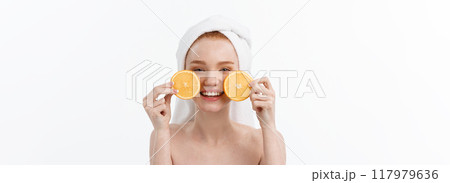 Great food for a healthy lifestyle. Beautiful young shirtless woman holding piece of orange standing against white background. 117979636