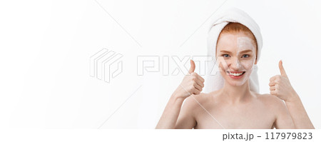 Beauty treatment. Woman applying moisturizing cream skin care product on face, making thumb up sign studio shot Beauty treatment. Woman applying moisturizing cream skin care product on face, making thumb up sign studio shot 117979823