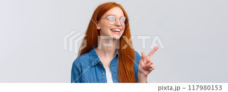 Close-up dreamy and cheerful, excited redhead female in glasses, dreaming about future opportunities, aspire enter famout university, pointing and looking upper left corner happy Close-up dreamy and cheerful, excited redhead female in glasses, dreaming about future opportunities, aspire enter famout university, pointing and looking upper left corner happy 117980153