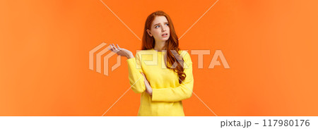 Troubled and unsure, indecisive cute redhead girl trying solve problem, searching resolve, looking perplexed upper left corner pondering, raise hand uncertain, confused, shrugging, orange background Troubled and unsure, indecisive cute redhead girl trying solve problem, searching resolve, looking perplexed upper left corner pondering, raise hand uncertain, confused, shrugging, orange background 117980176