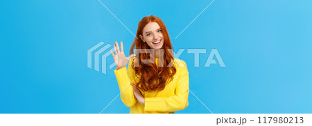 Cheerful, charismatic friendly redhead female showing high five, number fifth as making order, reservation or booking place for party, counting, standing blue background carefree in yellow sweater 117980213