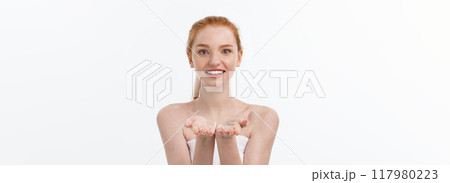Skin care beauty woman showing empty palm with copy space for product. Excited smiling Caucasian female beauty model isolated on white background. Skin care beauty woman showing empty palm with copy space for product. Excited smiling Caucasian female beauty model isolated on white background. 117980223