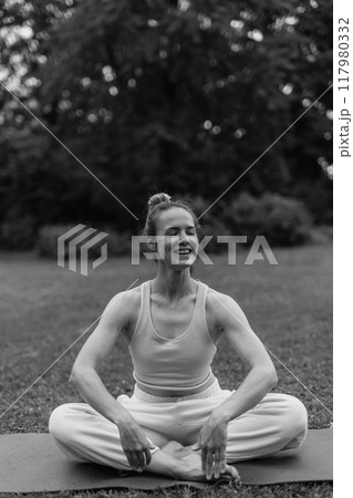 young woman athlete in sportswear practices yoga, enjoys training young woman athlete in sportswear practices yoga, enjoys training 117980332