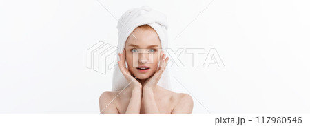beautiful model applying cosmetic cream treatment on her face on white. beautiful model applying cosmetic cream treatment on her face on white. 117980546