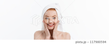 Surprised Beautiful Young Woman After Bath with A Towel On Her Head Isolated On white Background. Skin Care And Spa Theme. Surprised Beautiful Young Woman After Bath with A Towel On Her Head Isolated On white Background. Skin Care And Spa Theme. 117980594
