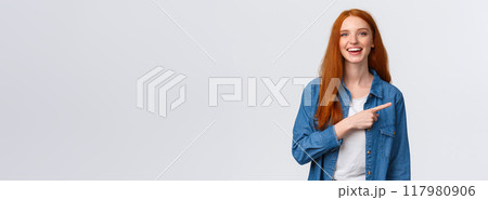 Carefree, friendly and happy outgoing redhead woman in denim shirt, pointing finger right and laughing at camera with beaming smile, standing white background, having discussion, communicate team Carefree, friendly and happy outgoing redhead woman in denim shirt, pointing finger right and laughing at camera with beaming smile, standing white background, having discussion, communicate team 117980906
