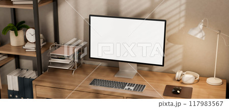 A minimalist computer desk featuring a computer and decor on the wooden desk in a room. 117983567