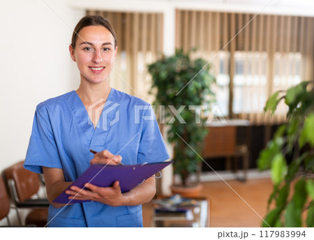 Woman doctor wear white medical uniform with folder of documents 117983994