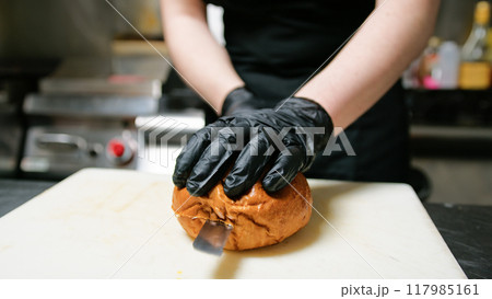 Knife Cutting Of A Bread Bun To Start Dish Preparation Knife Cutting Of A Bread Bun To Start Dish Preparation 117985161