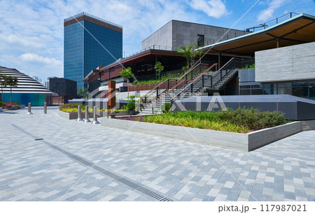 Modern business district featuring office buildings, green spaces, and pedestrian walkways Modern business district featuring office buildings, green spaces, and pedestrian walkways 117987021