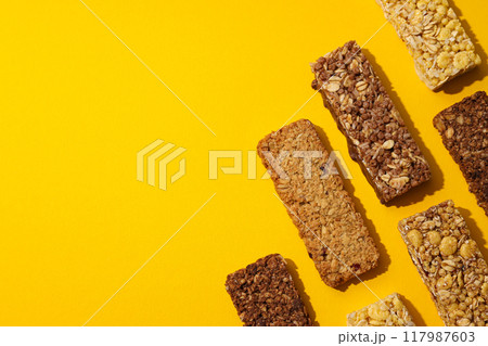 Delicious granola bars on a yellow background 117987603