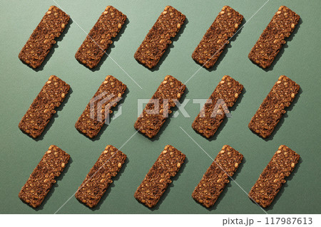 Tasty granola bar on a dark background Tasty granola bar on a dark background 117987613