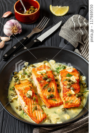 salmon piccata with lemon caper sauce in a pan salmon piccata with lemon caper sauce in a pan 117989550