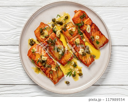 salmon piccata with lemon caper sauce on plate salmon piccata with lemon caper sauce on plate 117989554