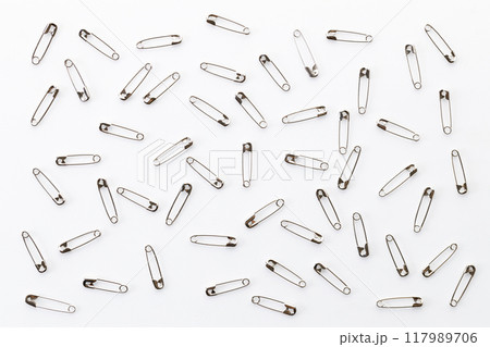 Safety pins on white background. Safety pins on white background. 117989706