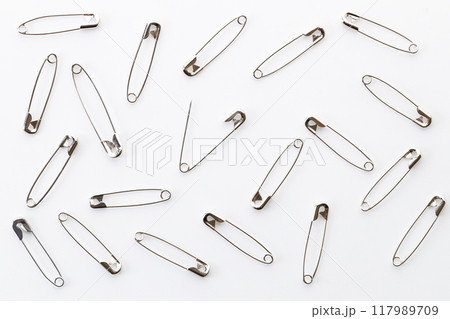 Safety pins on white background. Safety pins on white background. 117989709