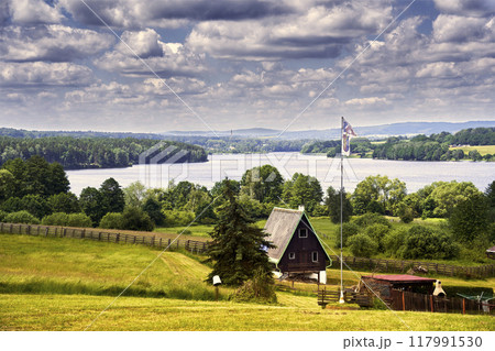 View over a meadow with a holiday home towards the Eger reservoir in the Czech Republic 117991530