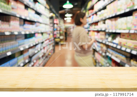 Empty wood table top with supermarket blurred background for product display Empty wood table top with supermarket blurred background for product display 117991714
