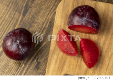 red ripe plum during cooking and slicing 117992501
