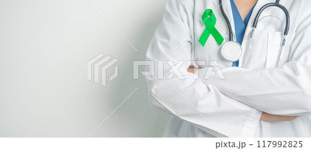 Doctor with green Ribbon for world Lymphoma Awareness September month, world Mental Health Day, Liver, Gallbladders, bile duct, cervical, kidney Cancer. Healthcare and world cancer day concept 117992825