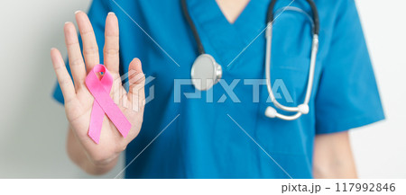 Pink October Breast Cancer Awareness month, woman doctor with pink Ribbon in hospital for support people life and illness. National cancer survivors month, Mother and World cancer day concept Pink October Breast Cancer Awareness month, woman doctor with pink Ribbon in hospital for support people life and illness. National cancer survivors month, Mother and World cancer day concept 117992846