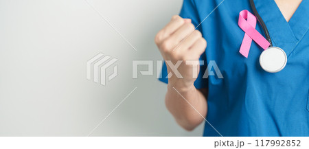 Pink October Breast Cancer Awareness month, woman doctor with pink Ribbon in hospital for support people life and illness. National cancer survivors month, Mother and World cancer day concept 117992852
