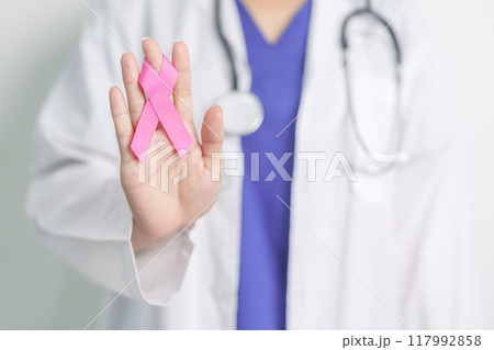 Pink October Breast Cancer Awareness month, woman doctor with pink Ribbon in hospital for support people life and illness. National cancer survivors month, Mother and World cancer day concept 117992858