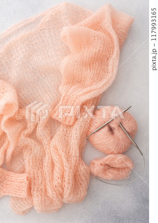 Home hobby, knitting a spider web sweater from pink threads Home hobby, knitting a spider web sweater from pink threads 117993165