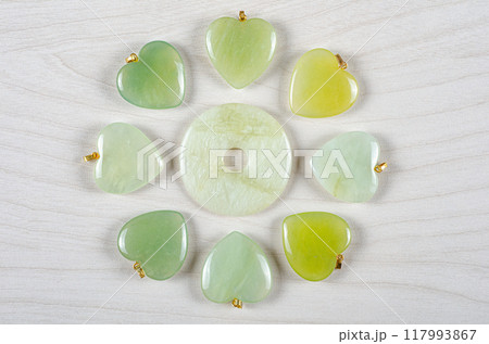 Green Dreams in Stone: Butter Jade's Versatility Shines in Artistic Layout of Donut Center and Radiating Heart-Shaped Pendants. Green Dreams in Stone: Butter Jade's Versatility Shines in Artistic Layout of Donut Center and Radiating Heart-Shaped Pendants. 117993867