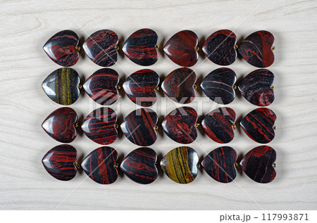 Passion in Every Stripe: Mesmerizing Collection of Red and Iron Tiger Eye Hearts Invites Exploration of Gemstone's Rich Variety. Passion in Every Stripe: Mesmerizing Collection of Red and Iron Tiger Eye Hearts Invites Exploration of Gemstone's Rich Variety. 117993871