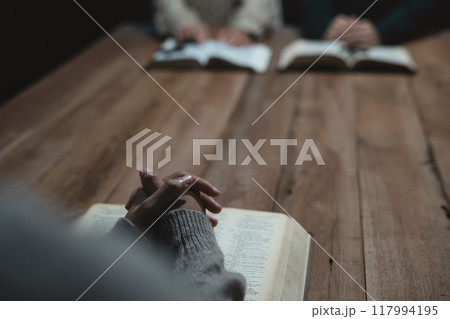 Asian men and women hands praying to god with the bible. Pray for god blessing. Religious beliefs Christian life crisis prayer to god. Asian men and women hands praying to god with the bible. Pray for god blessing. Religious beliefs Christian life crisis prayer to god. 117994195