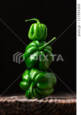 Tower from ripened green habanero peppers Tower from ripened green habanero peppers 117994269