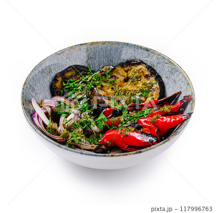 Grilled eggplant and red pepper salad with herbs and spices in a bowl Grilled eggplant and red pepper salad with herbs and spices in a bowl 117996763