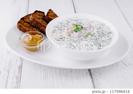 Okroshka serving with mustard and rye bread on white table Okroshka serving with mustard and rye bread on white table 117996818