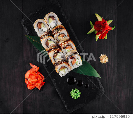 Sushi rolls set served on black stone slate plate 117996930