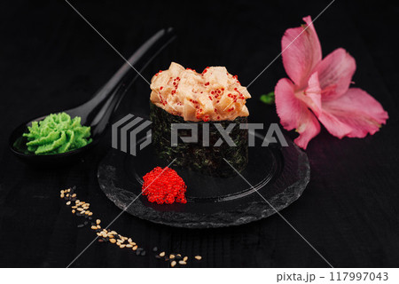 Gunkan sushi with spicy sauce, tobiko and wasabi on black background 117997043