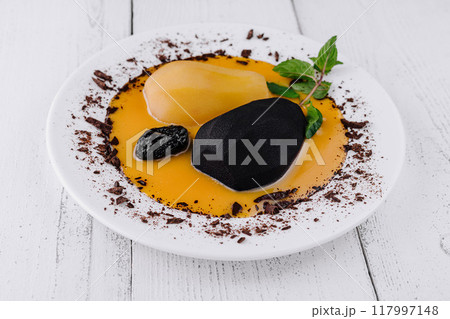 Pears poached in wine with chocolate sauce decorating modern gourmet restaurant dessert plate Pears poached in wine with chocolate sauce decorating modern gourmet restaurant dessert plate 117997148
