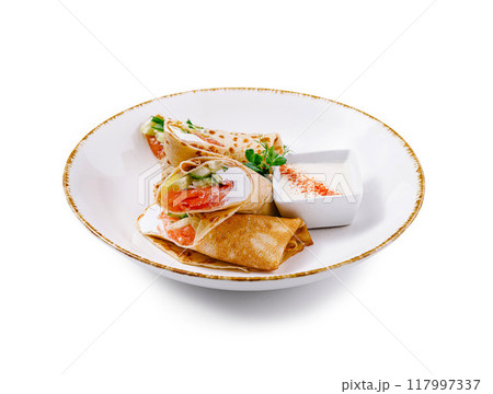 Pancakes with salmon and cream cheese filling on white plate 117997337