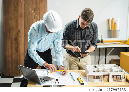 Architect or construction engineer caucasian plan on hard project at work,  industry professional team. 117997388