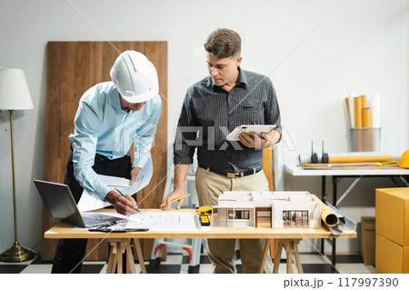 Architect or construction engineer caucasian plan on hard project at work,  industry professional team. 117997390