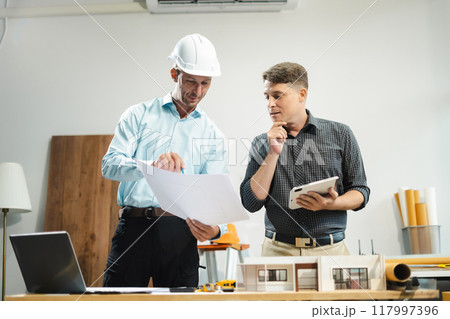 Architect or construction engineer caucasian plan on hard project at work,  industry professional team. 117997396