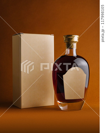Bottle of alcohol with blank label and cardboard packaging standing on orange background Bottle of alcohol with blank label and cardboard packaging standing on orange background 117998105