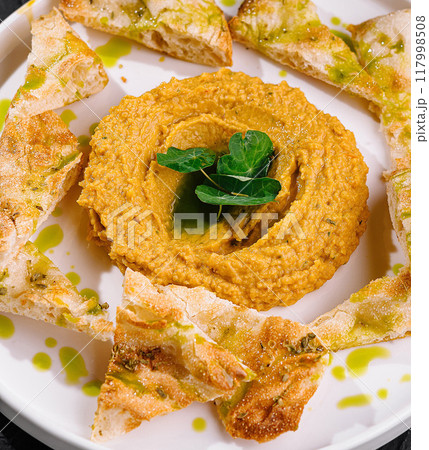 Gourmet hummus plate with pita chips Gourmet hummus plate with pita chips 117998508