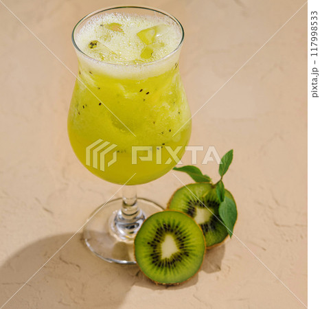 Fresh kiwi cocktail on sandy background Fresh kiwi cocktail on sandy background 117998533