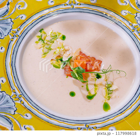 Elegant soup presentation in ornate plate Elegant soup presentation in ornate plate 117998618