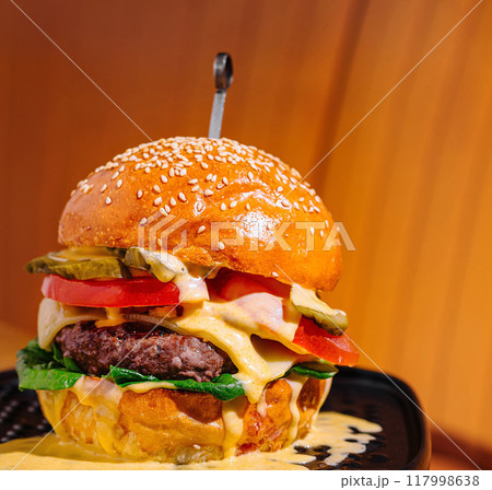 Gourmet cheeseburger on warm background 117998638