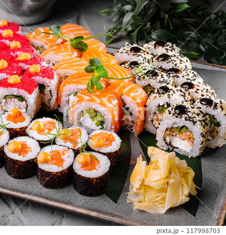 Assorted sushi platter on elegant table setting Assorted sushi platter on elegant table setting 117998703