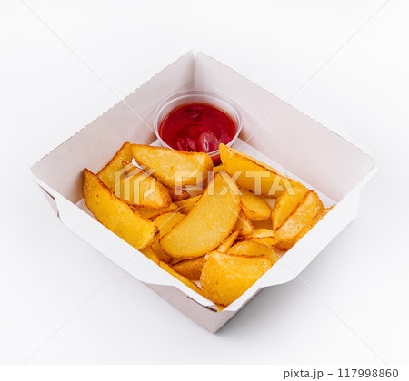 Crispy potato wedges in takeout box with ketchup 117998860